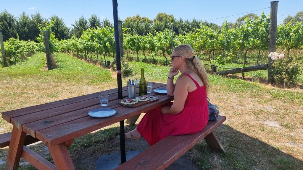 seating on a picnic bench outside at harman wines -  South Gippsland wineries