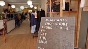 shop showing opening hours sign