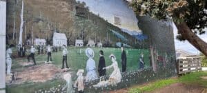 mural showing people picnicking in the park from last century