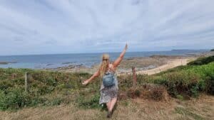 girl standing overlooking the beach 