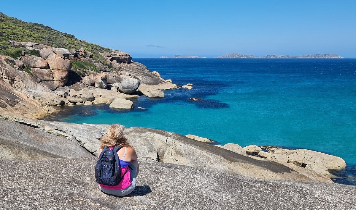 sitting on granite rocks looking at to sea at Squeaky beach