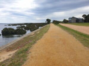 a compact sandy trail next to the water in Port Albet