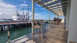 seating area outside fish and ships overlooking a boat