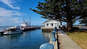 the fish and chip store sits on the jetty at Port Albert with boasts out front