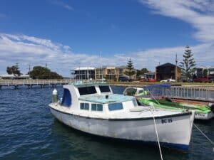 a boat tied up at the jetty in port albert