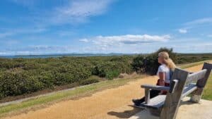 sitting on a park bench overlooking the water in Port Albert